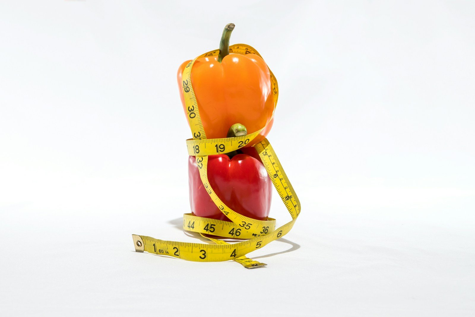 a measuring tape wrapped around a bell pepper